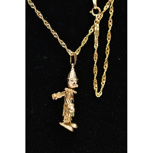 64 - A 9CT GOLD CLOWN PENDANT NECKLACE, the small articulated clown pendant, set with colourful stones to... 