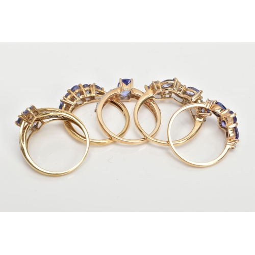 72 - FIVE 9CT GOLD TANZANITE RINGS, five stone tanzanite ring, comprising three oval tanzanite's,  two tr... 