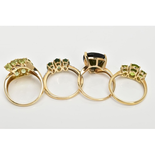 83 - FOUR 9CT GOLD GEMSET RINGS, to include a three stone ring, oval cut peridot, prong set with tapered ... 