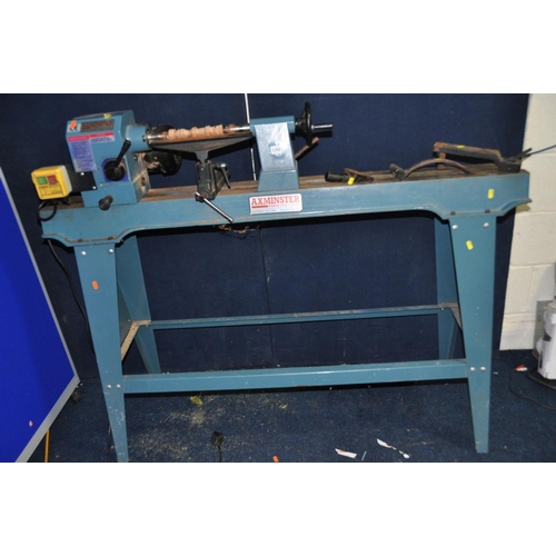 AN AXMINSTER APTC M950 WOODTURNING LATHE on stand, with three rests, a ...