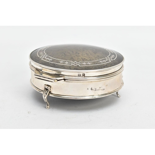 101 - A SILVER AND TORTOISESHELL BOX, of a circular form, plain polished body raised on three scroll feet,... 