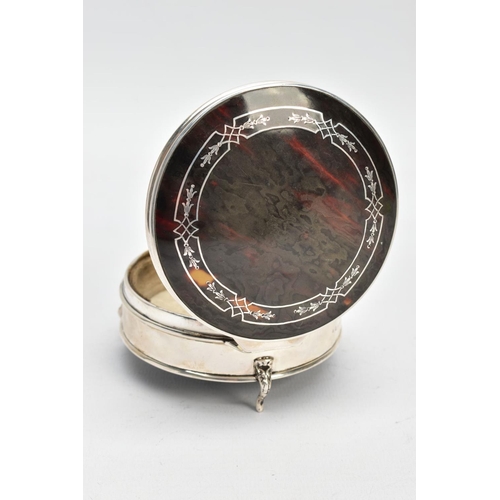 101 - A SILVER AND TORTOISESHELL BOX, of a circular form, plain polished body raised on three scroll feet,... 