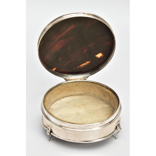 101 - A SILVER AND TORTOISESHELL BOX, of a circular form, plain polished body raised on three scroll feet,... 