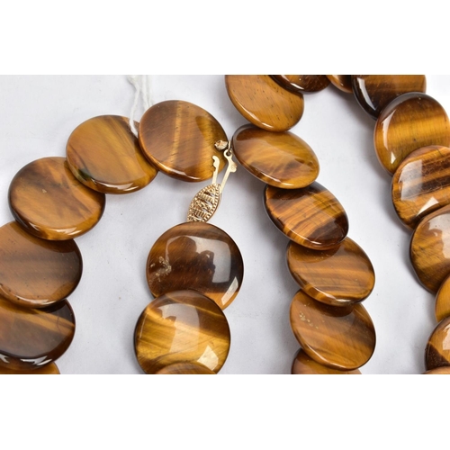 187 - A TIGERS EYE NECKLACE, necklace consisting of forty-three polished tigers eye circular shaped disks,... 