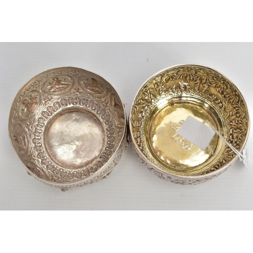 199 - TWO WHITE METAL DISHES, two dishes embossed with south Asian artwork, one dish embossed with deities... 