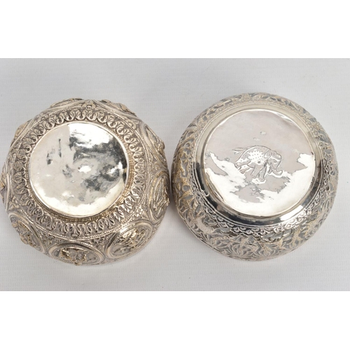 199 - TWO WHITE METAL DISHES, two dishes embossed with south Asian artwork, one dish embossed with deities... 