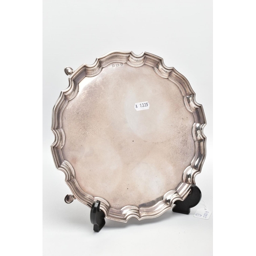 219 - A SILVER SALVER, circular design with a wavy rim, raised on four hoof feet, approximate width 25.5cm... 