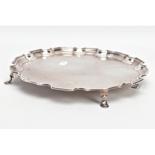 219 - A SILVER SALVER, circular design with a wavy rim, raised on four hoof feet, approximate width 25.5cm... 