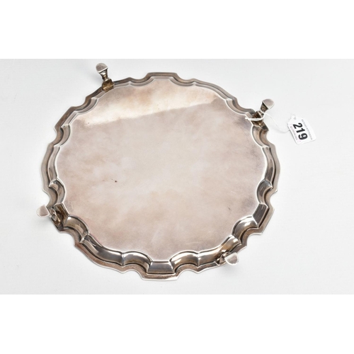 219 - A SILVER SALVER, circular design with a wavy rim, raised on four hoof feet, approximate width 25.5cm... 