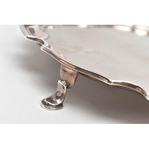 219 - A SILVER SALVER, circular design with a wavy rim, raised on four hoof feet, approximate width 25.5cm... 