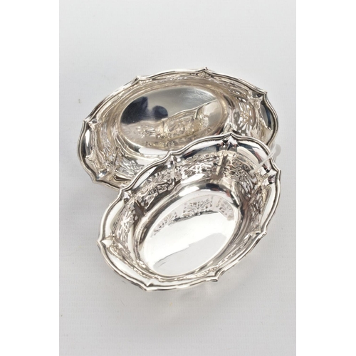 220 - TWO SILVER BONBON DISHES, each of an oval pierced from, wavy rims, hallmarked 'William Comyns & Sons... 
