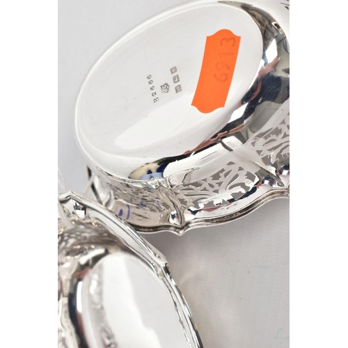 220 - TWO SILVER BONBON DISHES, each of an oval pierced from, wavy rims, hallmarked 'William Comyns & Sons... 