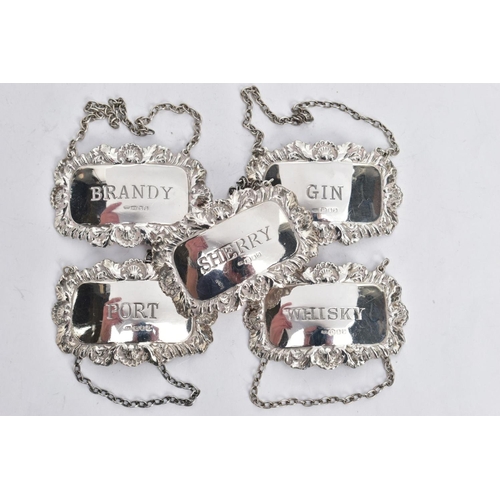 221 - FIVE SILVER DECANTER LABELS, each of a rectangular form with decorative floral and scroll rims, labe... 
