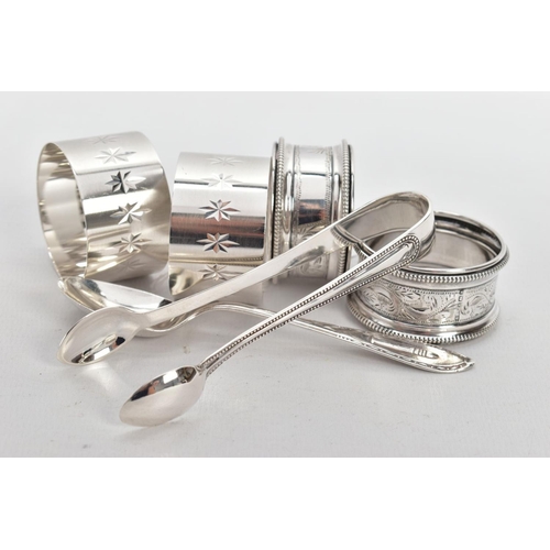 222 - FOUR SILVER NAPKIN RINGS, A PAIR OF SUGAR TONGS AND A TEASPOON, two napkin rings engraved with star ... 