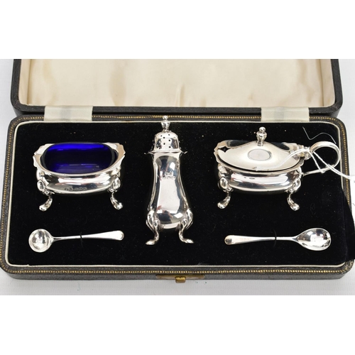 223 - A CASED GEORGE VI SILVER CONDIMENT SET, to include a silver salt and mustard each with a blue glass ... 