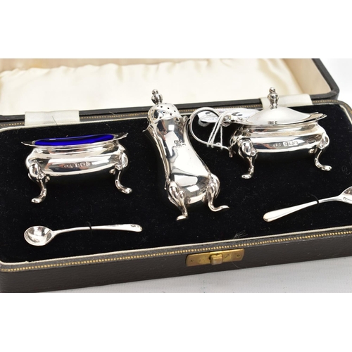 223 - A CASED GEORGE VI SILVER CONDIMENT SET, to include a silver salt and mustard each with a blue glass ... 