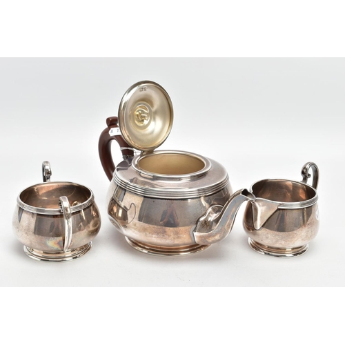 233 - A THREE PIECE SILVER TEA SET, to include a silver round teapot with a brown insulated handle, detail... 