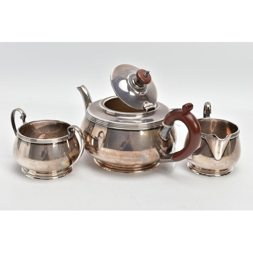 233 - A THREE PIECE SILVER TEA SET, to include a silver round teapot with a brown insulated handle, detail... 