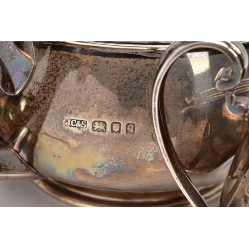 233 - A THREE PIECE SILVER TEA SET, to include a silver round teapot with a brown insulated handle, detail... 