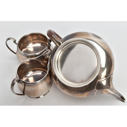 233 - A THREE PIECE SILVER TEA SET, to include a silver round teapot with a brown insulated handle, detail... 