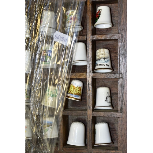 469 - FOUR DISPLAY TRAYS CONTAINING APPROXIMATELY FIVE HUNDRED AND TEN THIMBLES, mainly ceramic thimbles, ... 