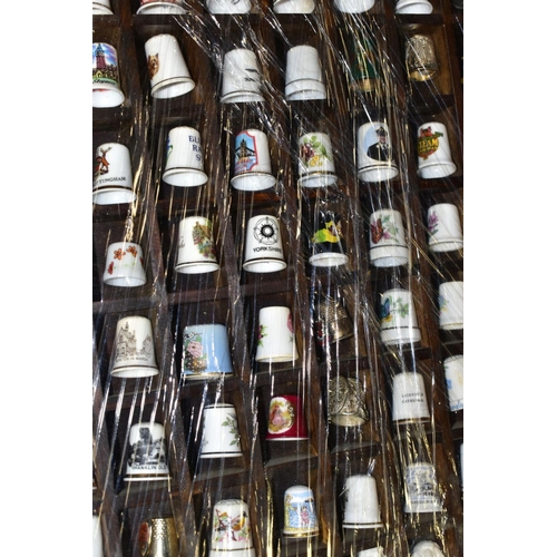 469 - FOUR DISPLAY TRAYS CONTAINING APPROXIMATELY FIVE HUNDRED AND TEN THIMBLES, mainly ceramic thimbles, ... 