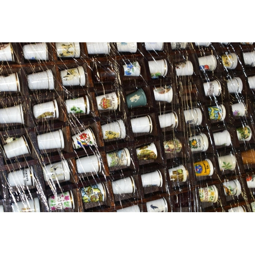 469 - FOUR DISPLAY TRAYS CONTAINING APPROXIMATELY FIVE HUNDRED AND TEN THIMBLES, mainly ceramic thimbles, ... 