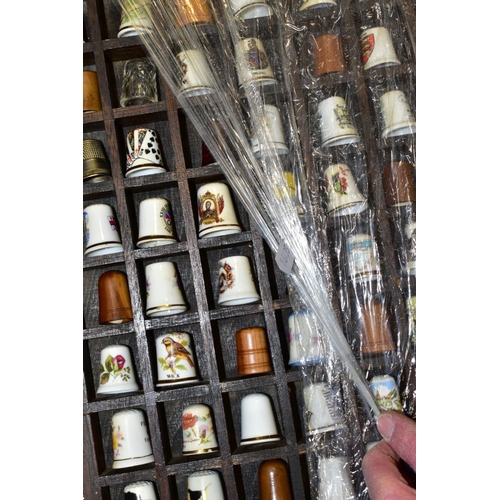 469 - FOUR DISPLAY TRAYS CONTAINING APPROXIMATELY FIVE HUNDRED AND TEN THIMBLES, mainly ceramic thimbles, ... 