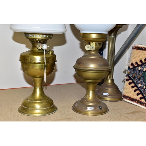 478 - TWO 2OTH CENTURY BRASS BASED OIL LAMPS, A TABLE LAMP IN A SIMILAR STYLE AND TWO TURKISH SYNTHETIC RU... 