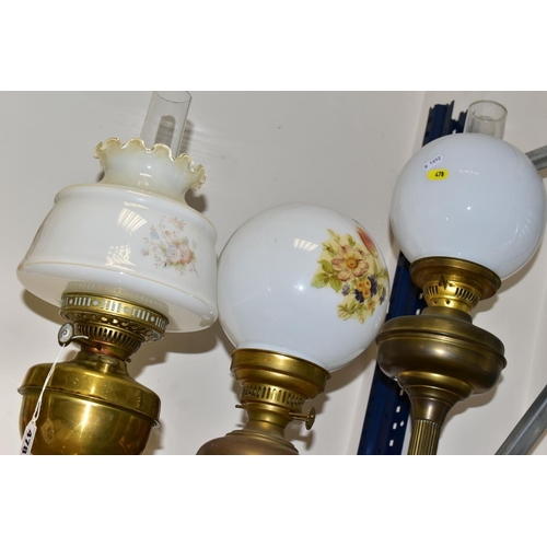 478 - TWO 2OTH CENTURY BRASS BASED OIL LAMPS, A TABLE LAMP IN A SIMILAR STYLE AND TWO TURKISH SYNTHETIC RU... 