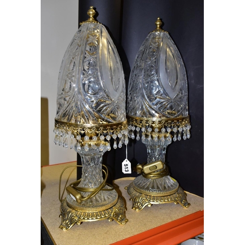 513 - A PAIR OF KLEIN BACCARAT CRYSTAL TABLE LAMPS, with a diamond cut crystal body on a brass base, elong... 