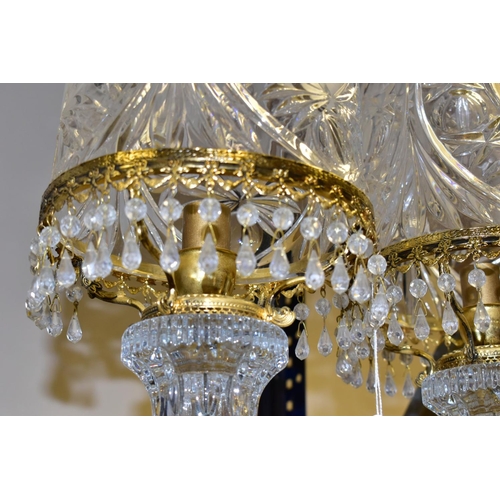 513 - A PAIR OF KLEIN BACCARAT CRYSTAL TABLE LAMPS, with a diamond cut crystal body on a brass base, elong... 