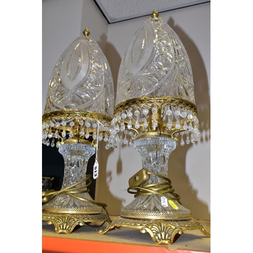 513 - A PAIR OF KLEIN BACCARAT CRYSTAL TABLE LAMPS, with a diamond cut crystal body on a brass base, elong... 