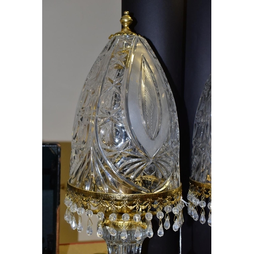 513 - A PAIR OF KLEIN BACCARAT CRYSTAL TABLE LAMPS, with a diamond cut crystal body on a brass base, elong... 