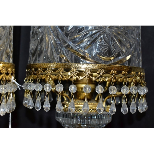 513 - A PAIR OF KLEIN BACCARAT CRYSTAL TABLE LAMPS, with a diamond cut crystal body on a brass base, elong... 