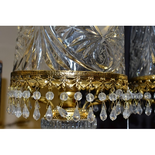 513 - A PAIR OF KLEIN BACCARAT CRYSTAL TABLE LAMPS, with a diamond cut crystal body on a brass base, elong... 