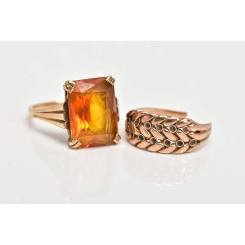 48 - TWO YELLOW METAL RINGS, the first designed with a four claw set, rectangular cut citrine, textured t... 