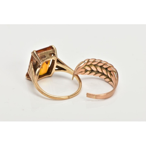 48 - TWO YELLOW METAL RINGS, the first designed with a four claw set, rectangular cut citrine, textured t... 