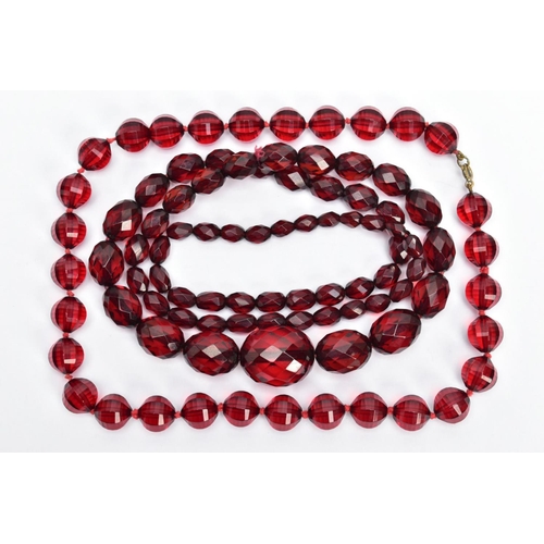 58 - TWO SETS OF FACETED CHERRY AMBER PLASTIC BEAD NECKLACES, the first designed with circular faceted be... 