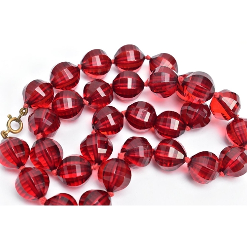 58 - TWO SETS OF FACETED CHERRY AMBER PLASTIC BEAD NECKLACES, the first designed with circular faceted be... 