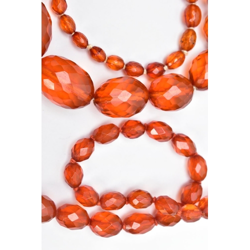 60 - TWO SETS OF ORANGE FACETED PLASTIC BEAD NECKLACES, each designed with graduated, faceted oval beads,... 