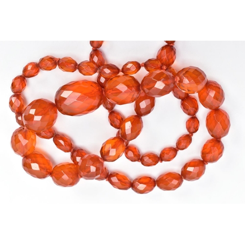 60 - TWO SETS OF ORANGE FACETED PLASTIC BEAD NECKLACES, each designed with graduated, faceted oval beads,... 