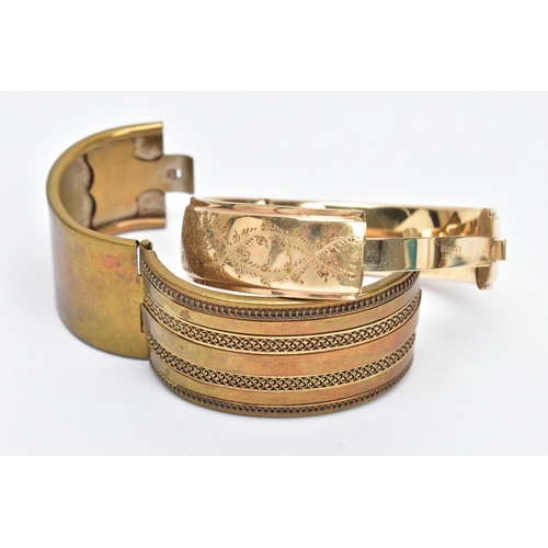 66 - A ROLLED GOLD BANGLE AND ONE OTHER, the rolled gold bangle with a floral design to one side, fitted ... 