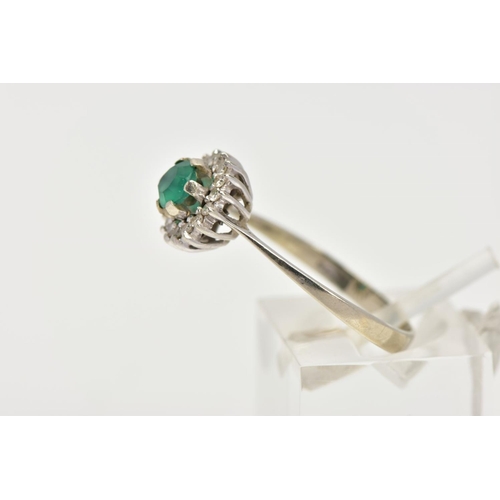 8 - A GREEN CHALCEDONY AND DIAMOND CLUSTER RING, the central circular green chalcedony within a single c... 