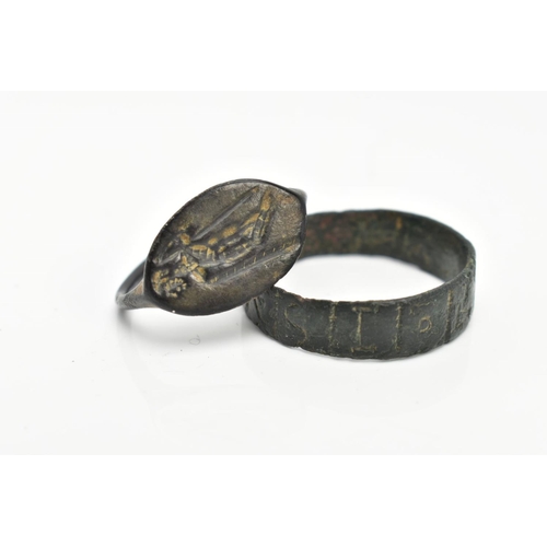 82 - TWO EXCAVATED RINGS, two rings believed to be Roman, one ring featuring engraved lettering, the seco... 