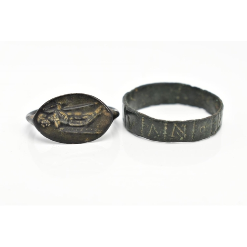 82 - TWO EXCAVATED RINGS, two rings believed to be Roman, one ring featuring engraved lettering, the seco... 