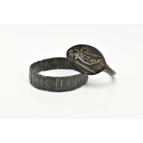 82 - TWO EXCAVATED RINGS, two rings believed to be Roman, one ring featuring engraved lettering, the seco... 
