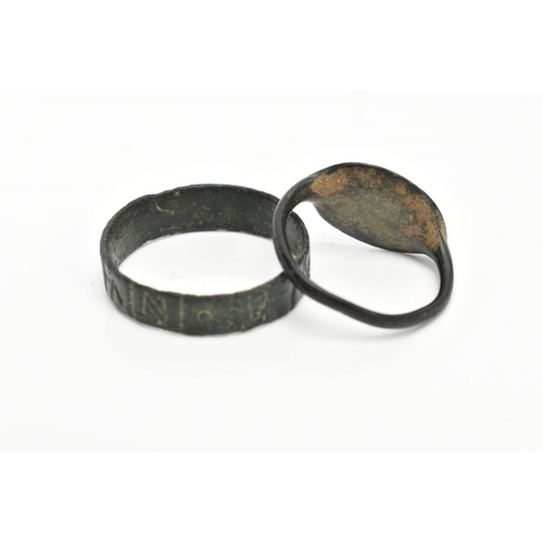 82 - TWO EXCAVATED RINGS, two rings believed to be Roman, one ring featuring engraved lettering, the seco... 