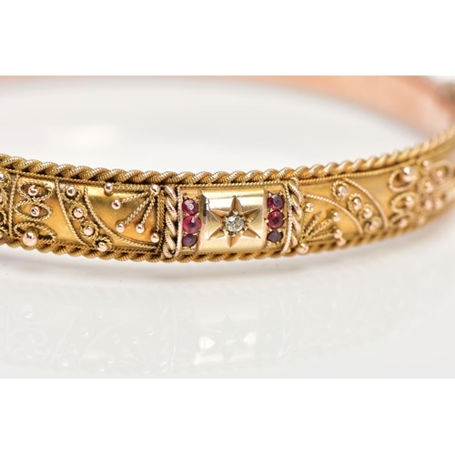 98 - AN EARLY 20TH CENTURY GOLD BANGLE, a 9ct gold hollow hinged bangle, set with a single rose cut diamo... 