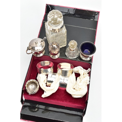 101 - A SET OF SILVER NAPKIN RINGS AND SILVER CONDIMENTS ITEMS, four silver hammered finished napkin rings... 